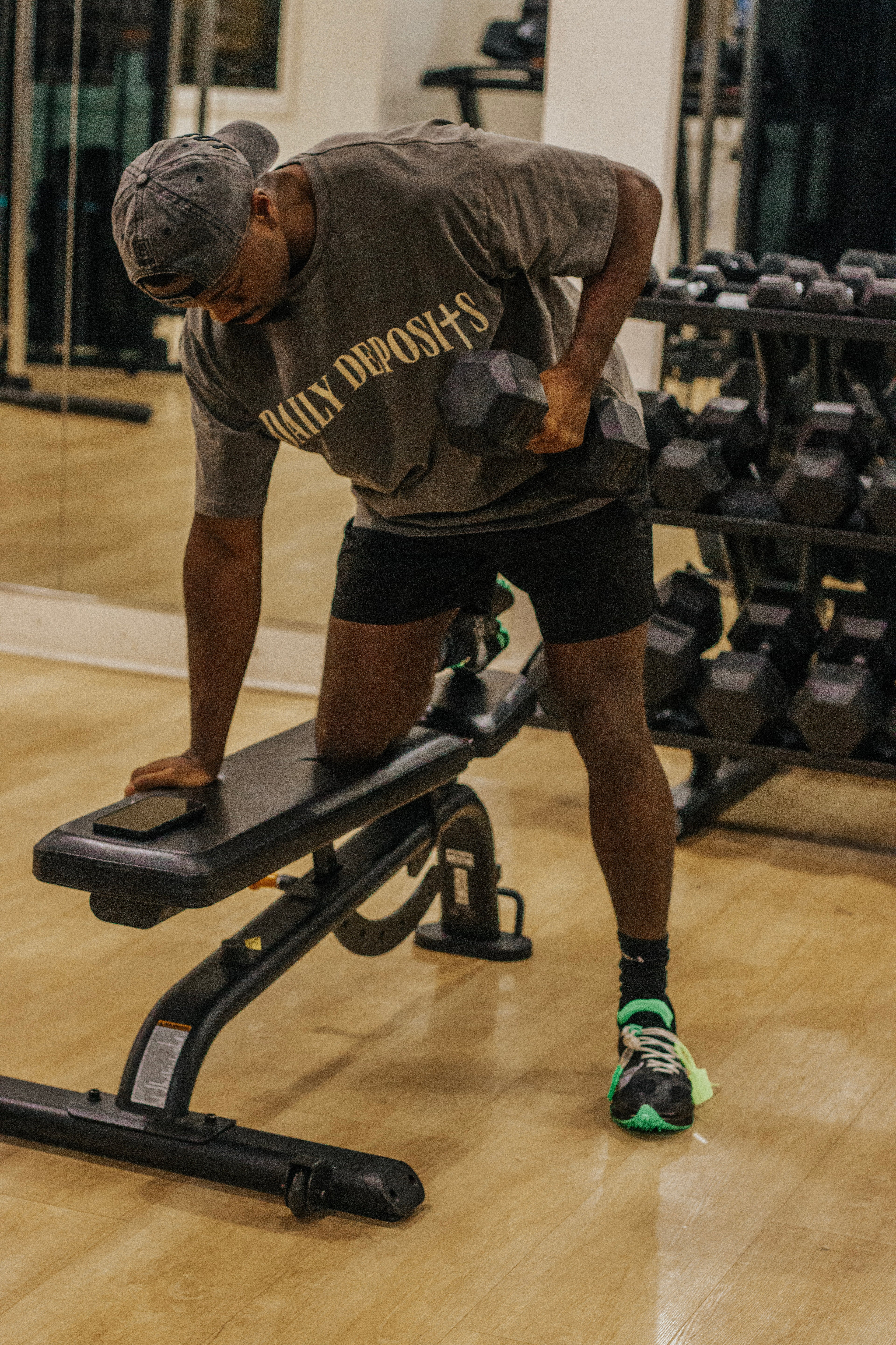 Person lifting weights on a bench in a gym setting